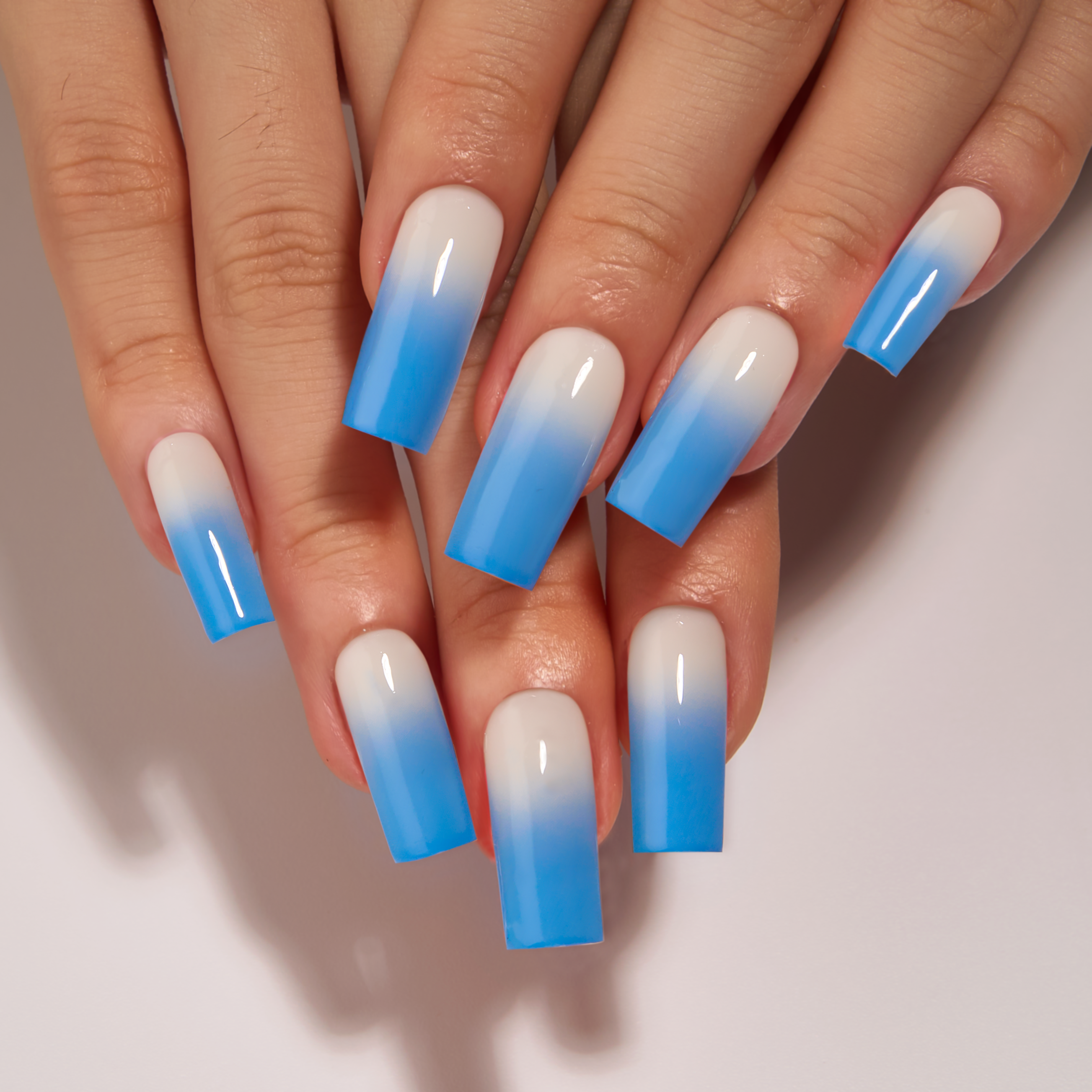 Arctic Fade long square press-on nails worn on a hand
