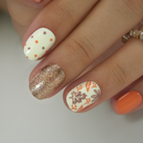 Autumn Confetti Rs squoval press-on nails worn on a hand