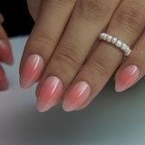Blossom Veil short almond press-on nails worn on a hand