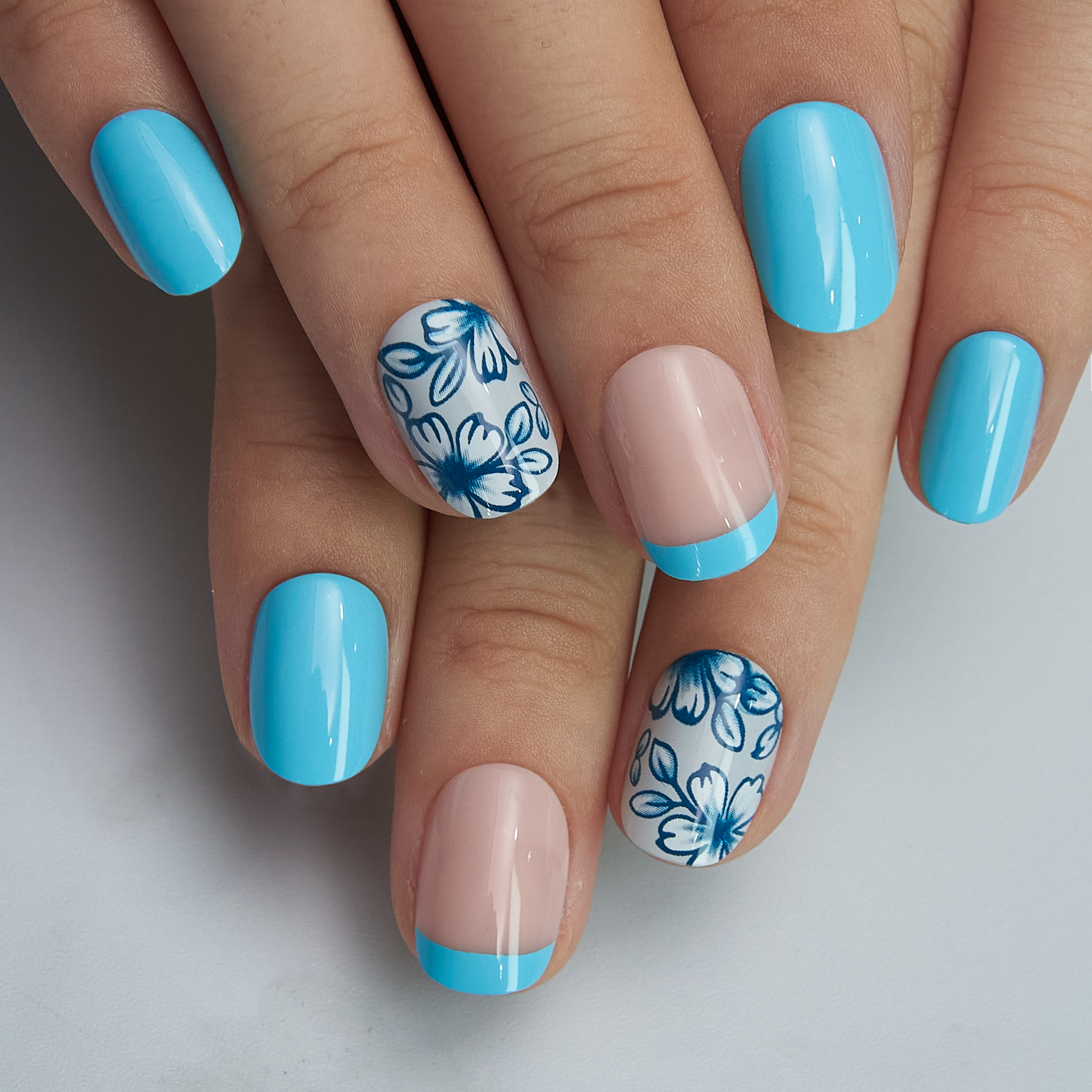 Blue Blossom Rs squoval press-on nails worn on a hand