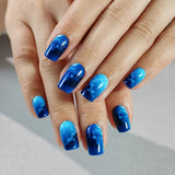 Blue Cosmos medium squoval press-on nails worn on a hand
