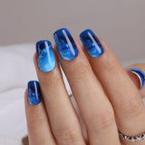 Blue Cosmos medium squoval press-on nails from the side