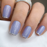 Blue Magic Rose short squoval press-on nails worn on a hand