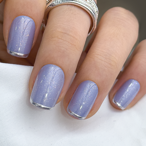 Blue Magic Rose short squoval press-on nails worn on a hand