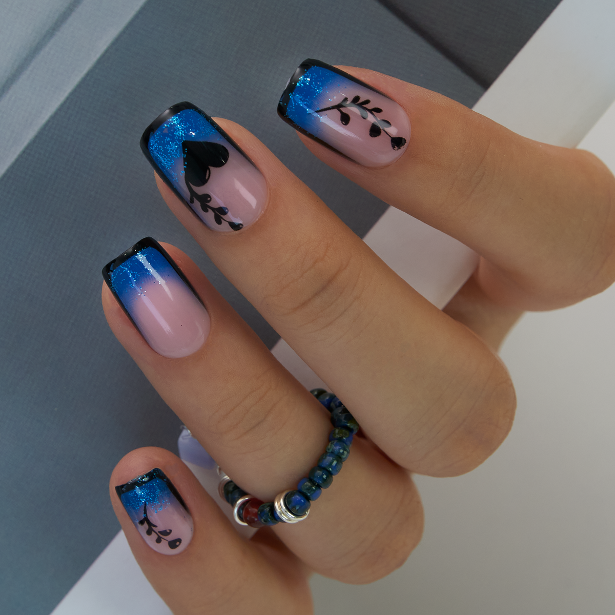 Blue Mirage medium squoval press-on nails worn on a hand