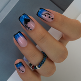 Blue Mirage medium squoval press-on nails worn on a hand
