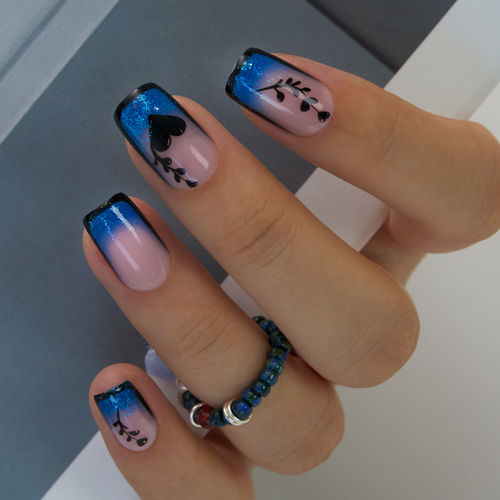 Blue Mirage medium squoval press-on nails worn on a hand