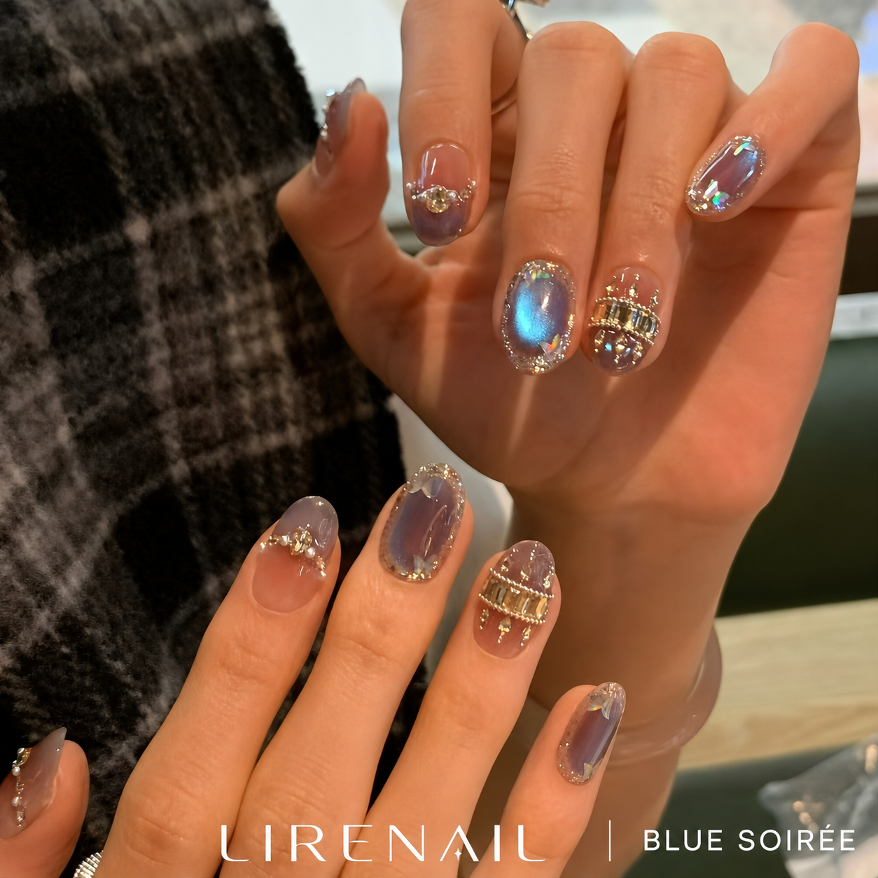 Blue Soiree press-on nails worn on both hands