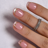 Blush Glitz short squoval press-on nails worn on a hand