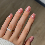 Blush Glossy short squoval press-on nails worn on a hand