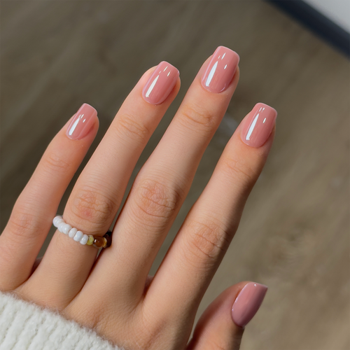 Blush Glossy short squoval press-on nails worn on a hand