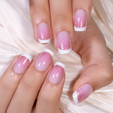 Blush Kiss short squoval press-on nails worn on a hand