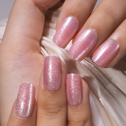 Blush Whisper medium squoval press-on nails worn on a hand