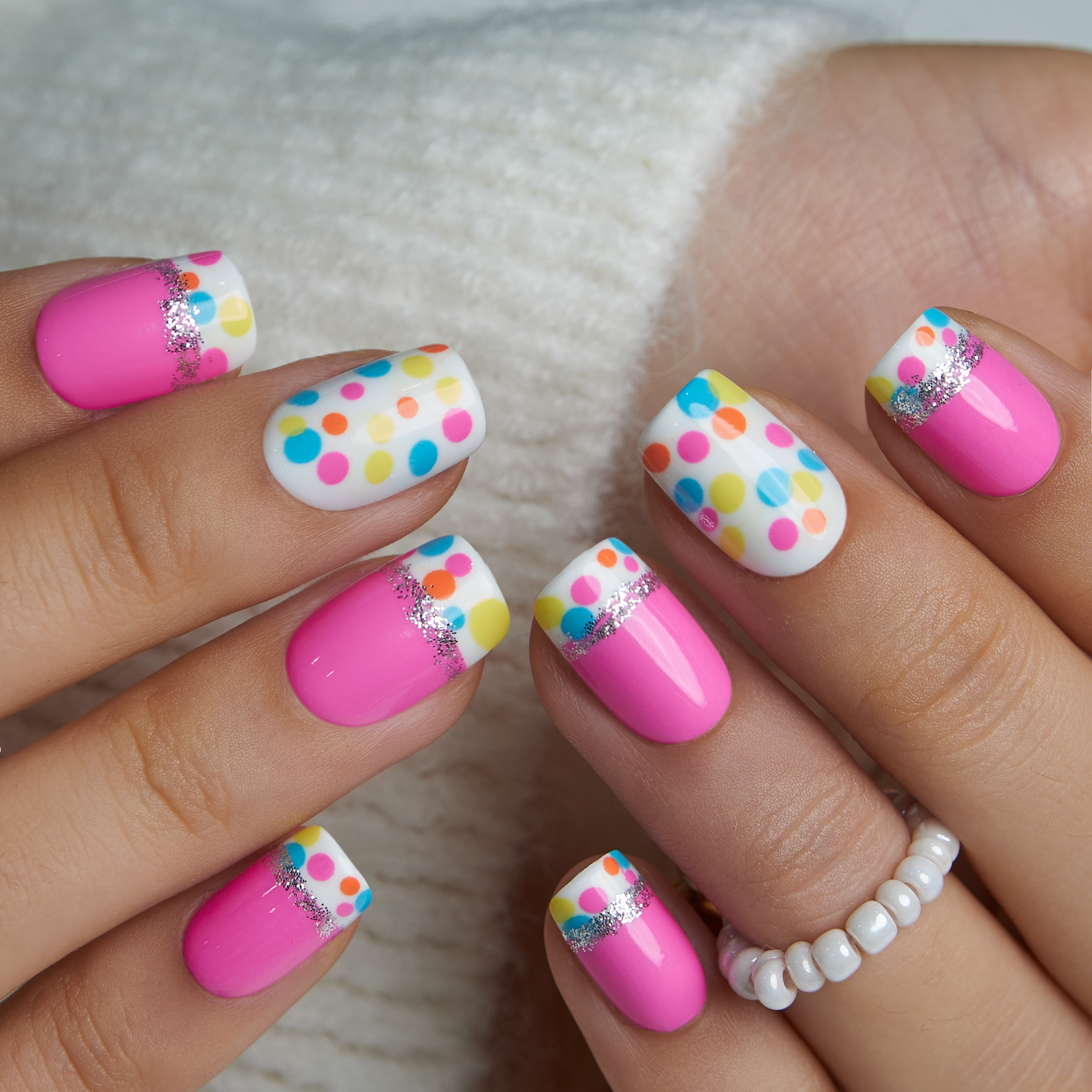 Candy Dot Dream short squoval press-on nails worn on a hand