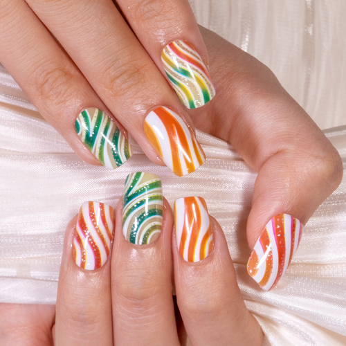 Candy Swirl medium squoval press-on nails worn on a hand