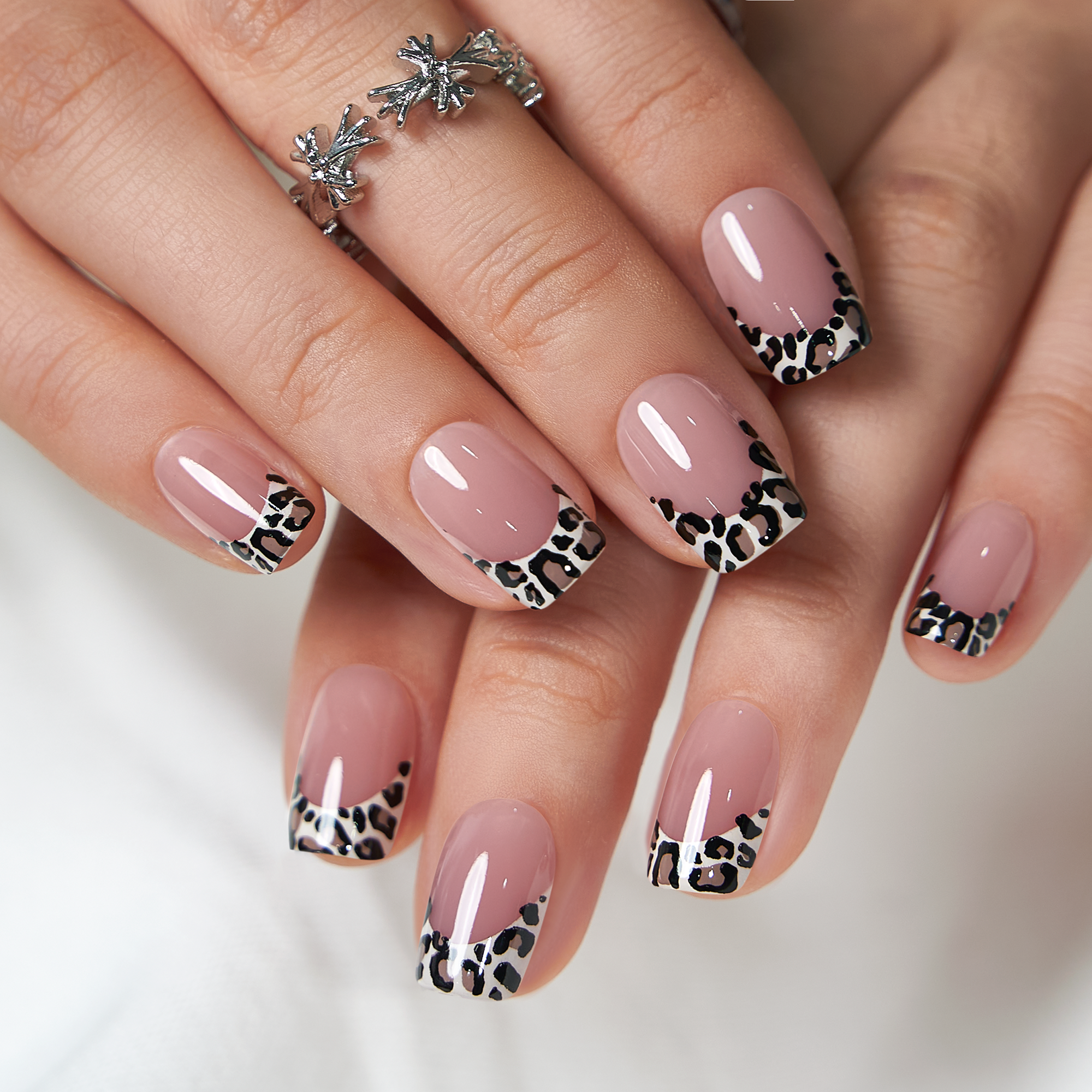 Chic Brown short squoval press-on nails worn on a hand