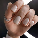 Chic Mickey Gray short squoval press-on nails worn on a hand