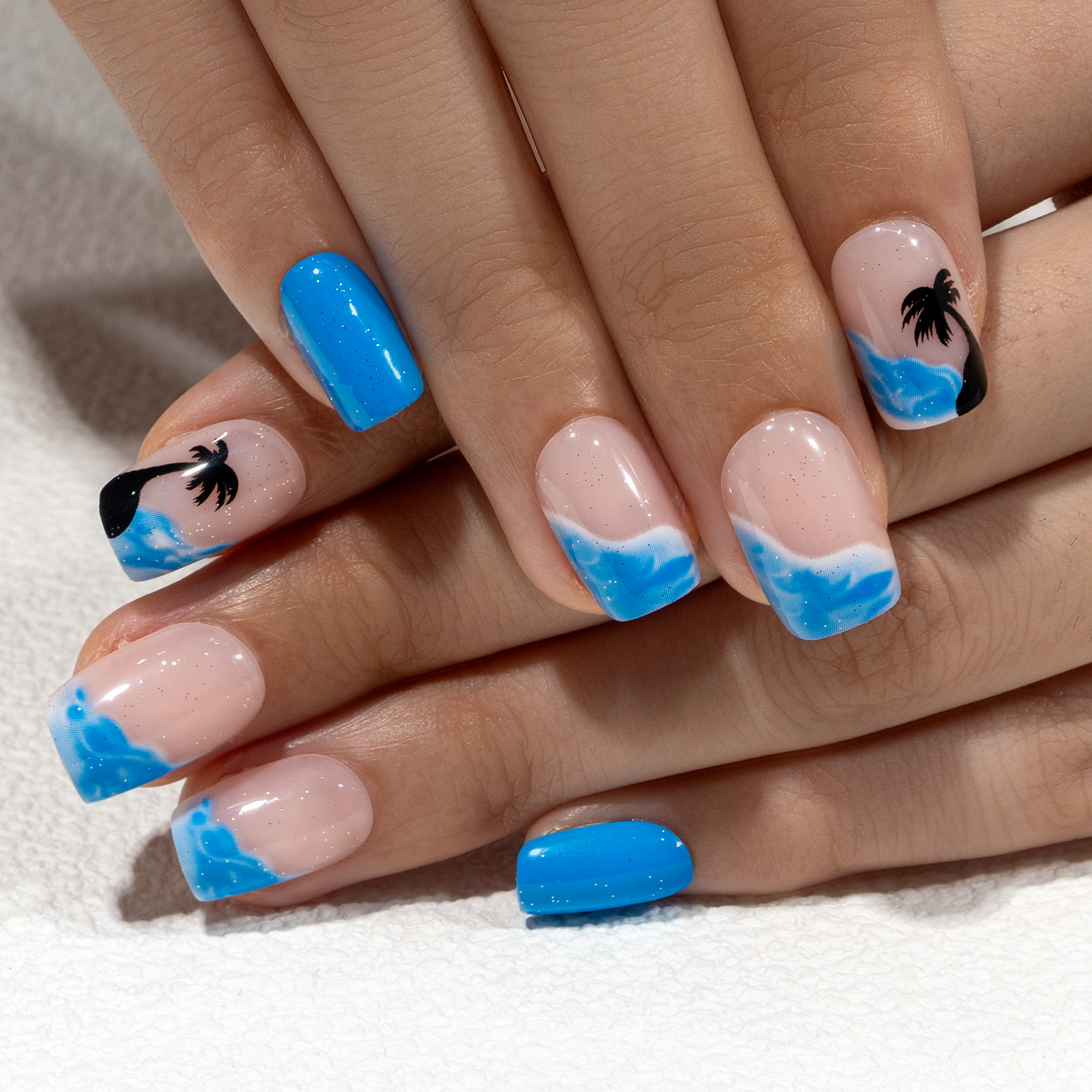 Coconut Palm short squoval press-on nails worn on a hand