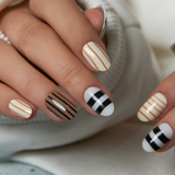 Coffee Line short oval press-on nails worn on a hand