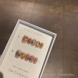 Colorful Stars press-on nails packaging with nude base, colorful star decals and crystal accents