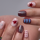 Crimson Swirl Rs squoval press-on nails worn on a hand