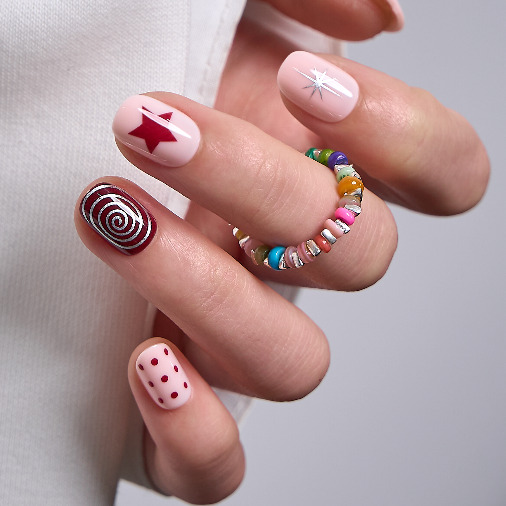 Crimson Swirl Rs squoval press-on nails from the side