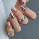 Crystal Dust short squoval press-on nails worn on a hand
