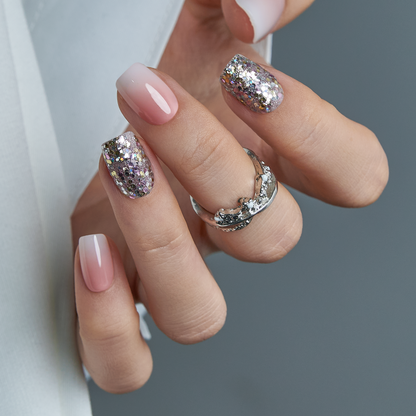 Crystal Dust short squoval press-on nails worn on a hand