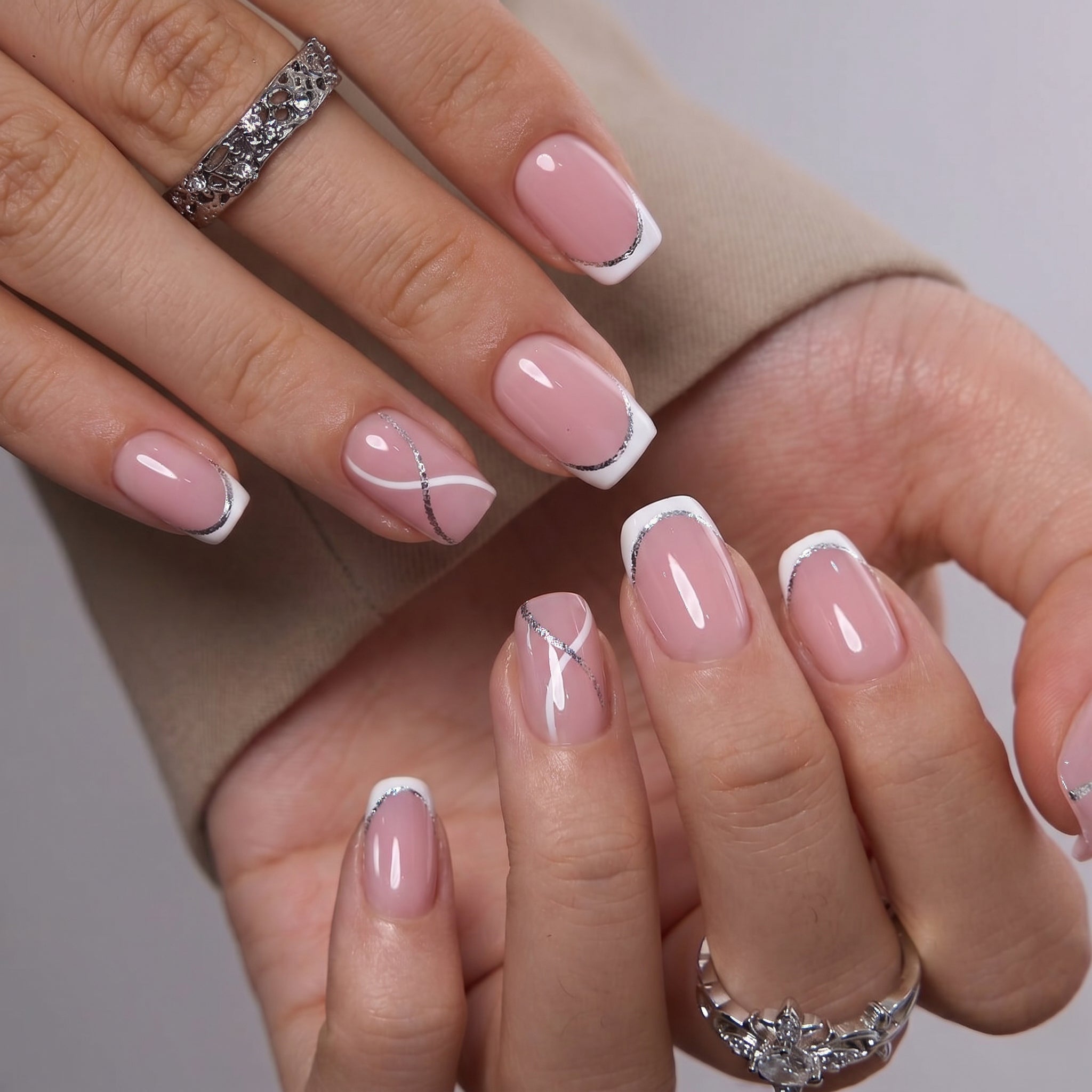 Crystal Whisper short squoval press-on nails worn on a hand