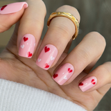 Cupid Touch short squoval press-on nails worn on a hand
