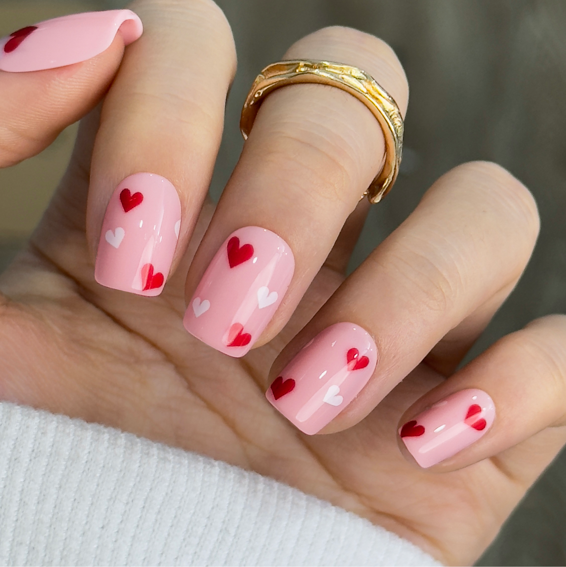 Cupid Touch short squoval press-on nails worn on a hand