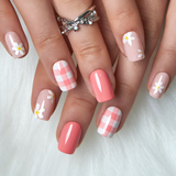 Daisy Picnic short squoval press-on nails worn on a hand