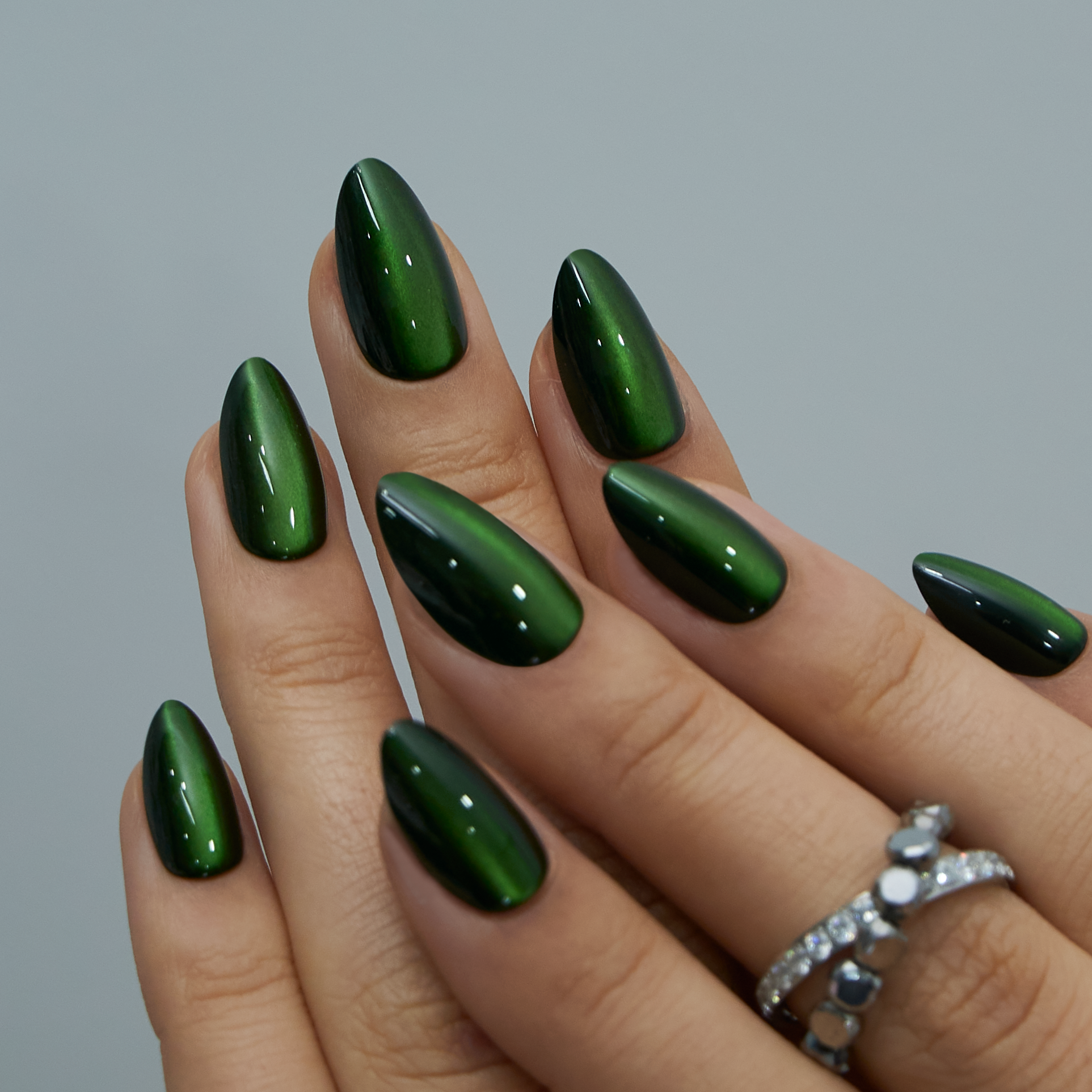 Dark Forest short almond press-on nails worn on a hand