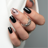 Dark Kiss medium squoval press-on nails worn on a hand