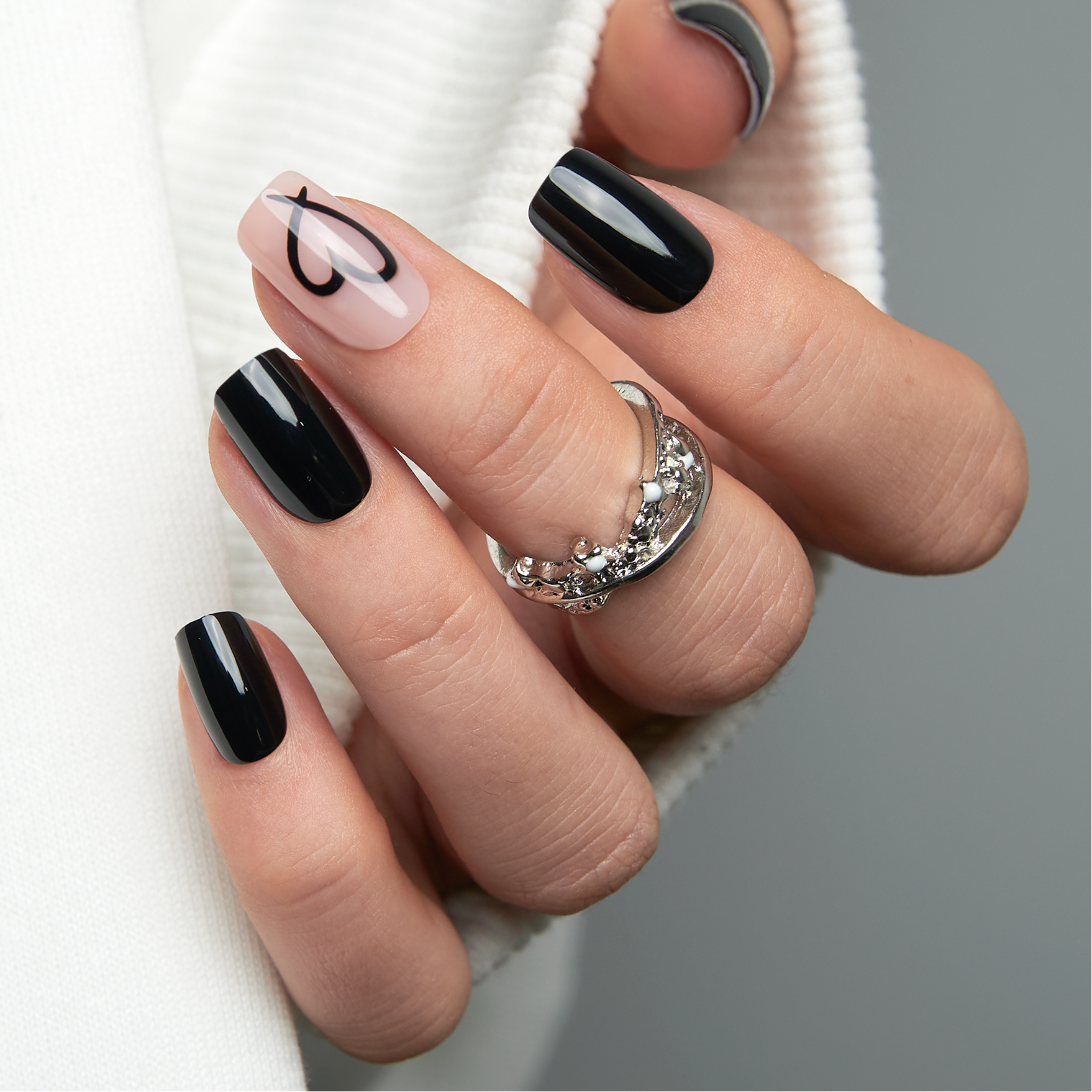 Dark Kiss medium squoval press-on nails worn on a hand