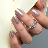 Dazzling Galaxy short squoval press-on nails worn on a hand