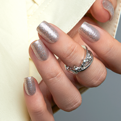 Dazzling Galaxy short squoval press-on nails worn on a hand