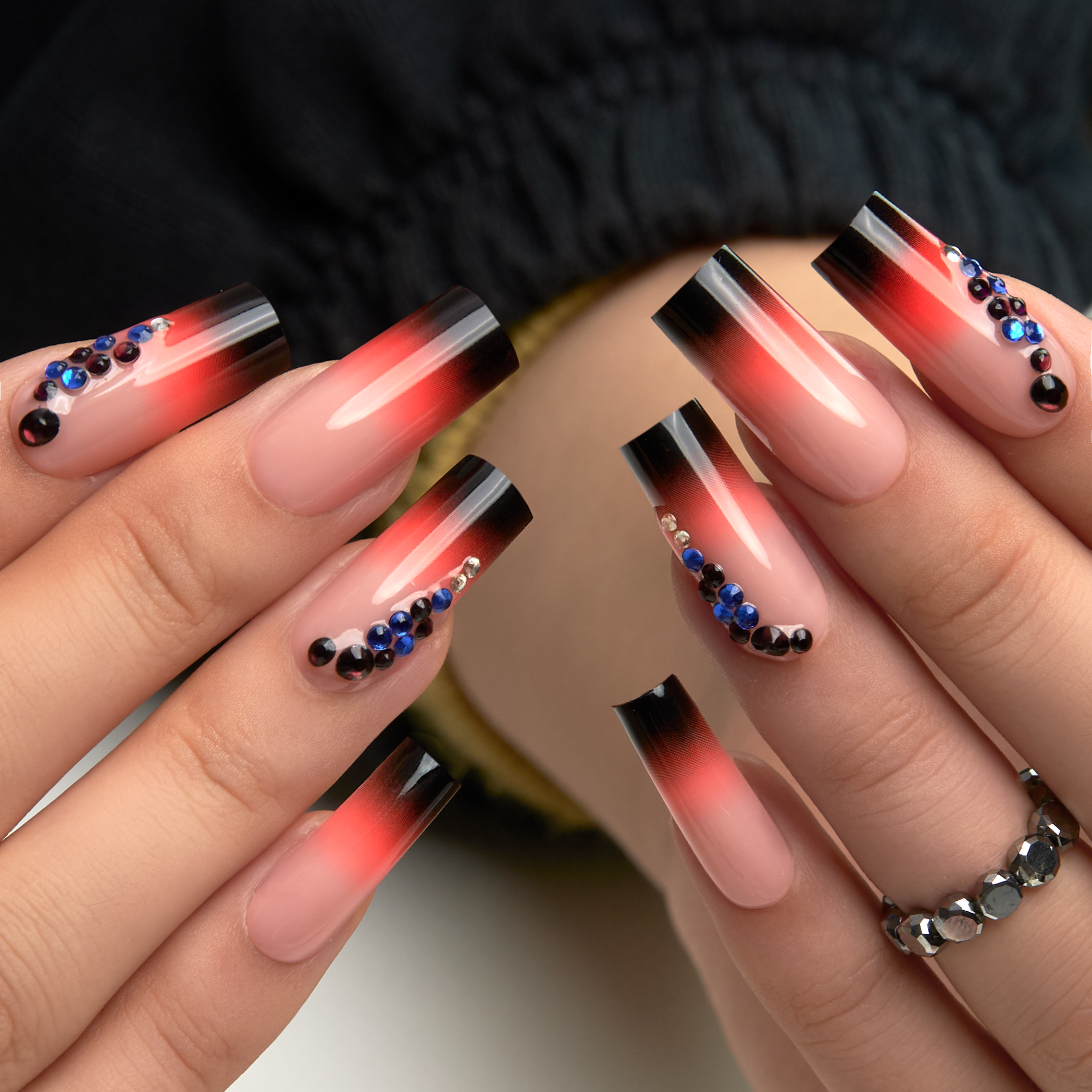 Designer S Pick Crimson Diamond long square press-on nails worn on a hand
