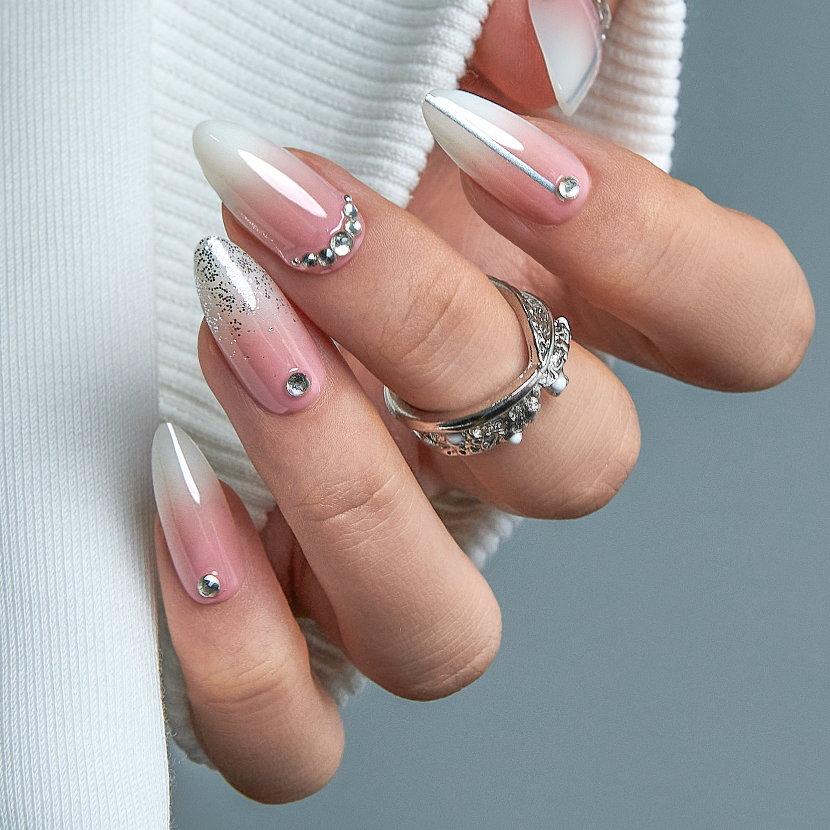 Designer S Pick Crystal Veil L stiletto press-on nails worn on a hand