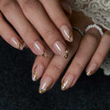 Designer S Pick Diamond Nude short almond press-on nails worn on a hand