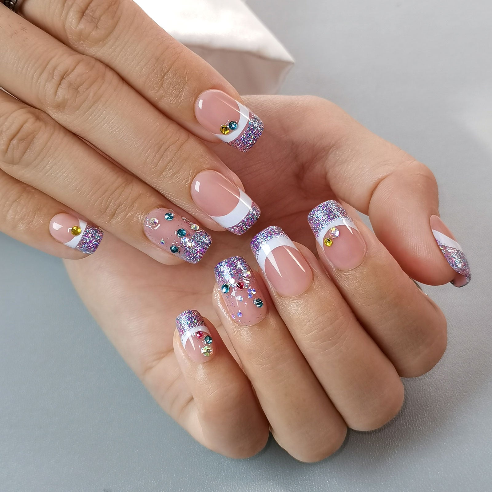 Designer S Pick Glitter Crown medium squoval press-on nails worn on a hand