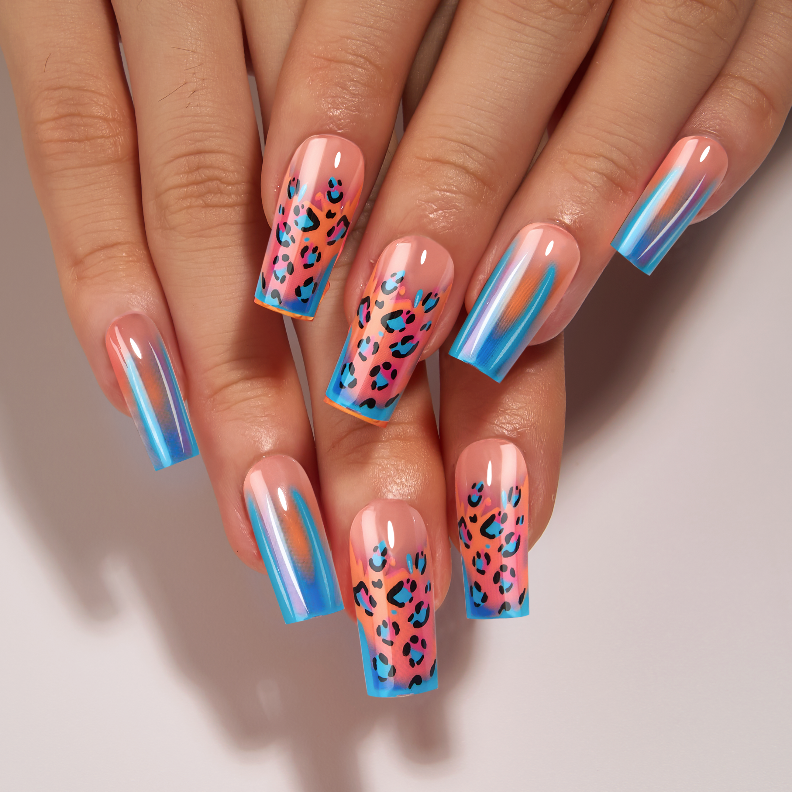 Designer S Pick Laser Leopard long square press-on nails worn on a hand