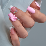Designer S Pick Pink Fairy medium squoval press-on nails worn on a hand