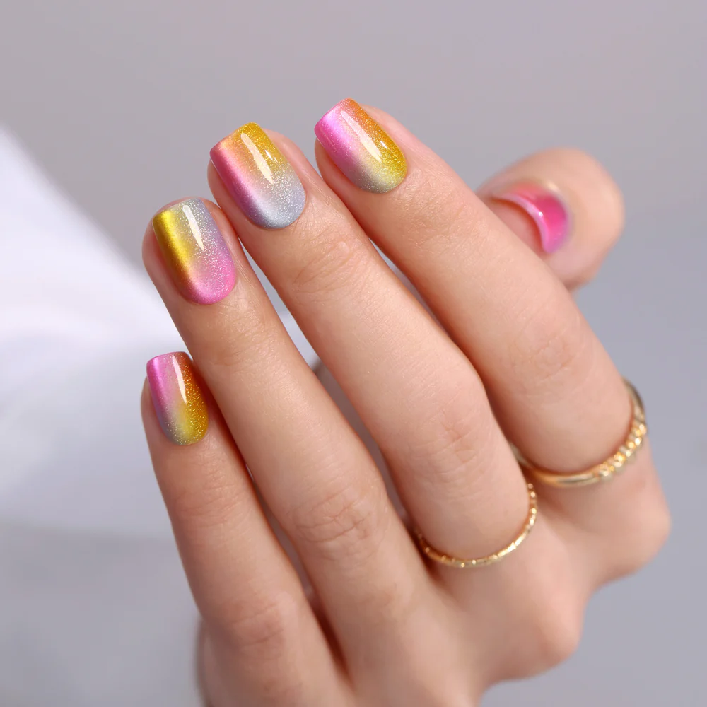 Designer S Pick Rainbow Glow short squoval press-on nails worn on a hand