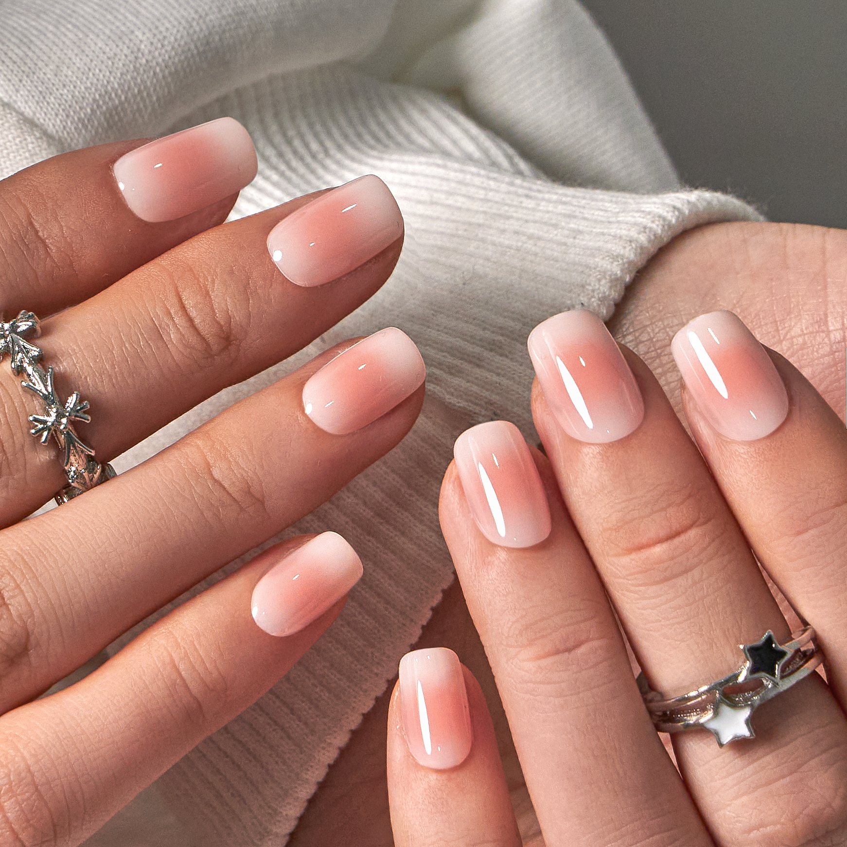 Dew Touch short squoval press-on nails worn on a hand
