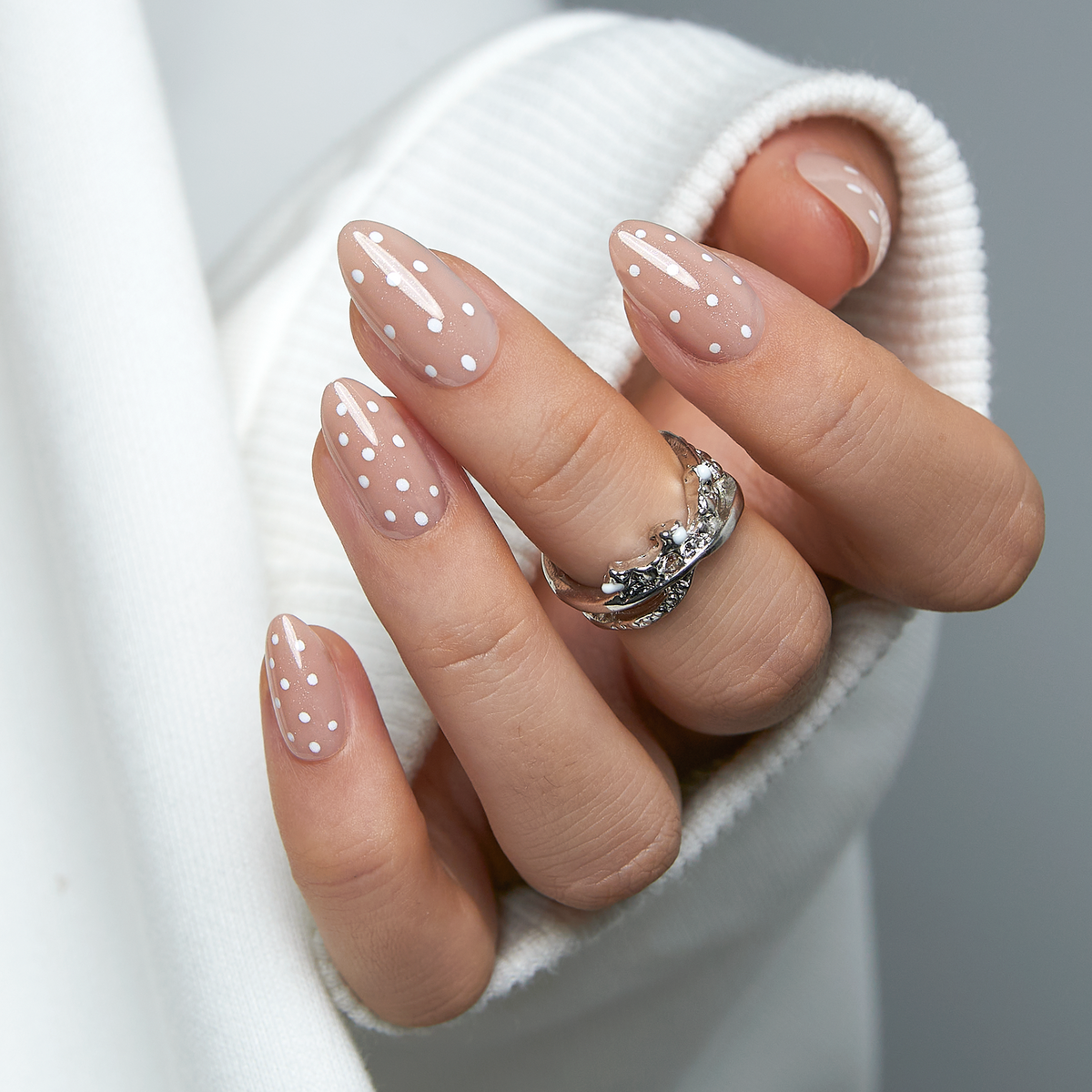 Dotted Milk Glow short almond nail detail