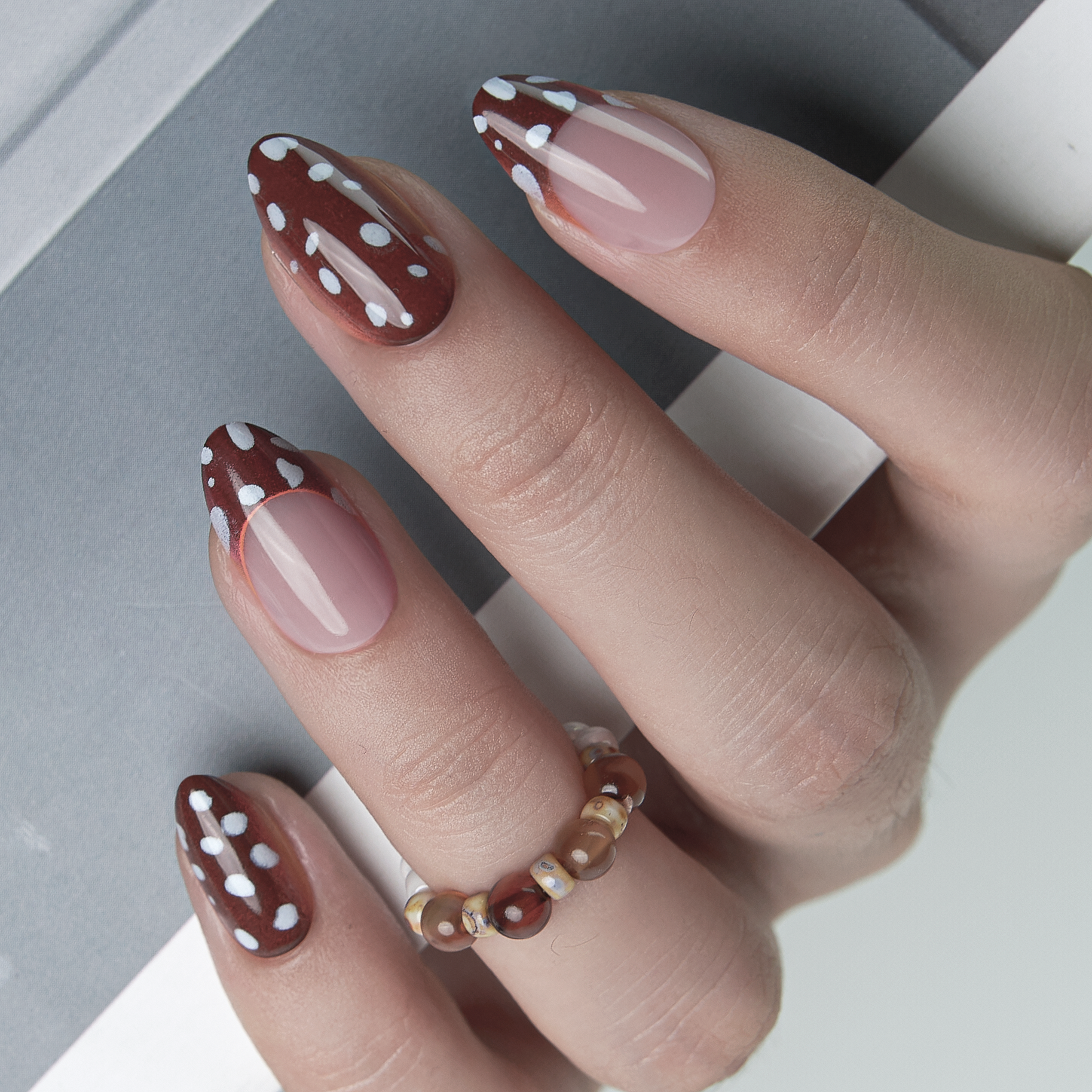 Dotty Delight short almond press-on nails from the side