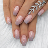 Elegant Fade medium squoval press-on nails worn on a hand