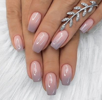 Elegant Fade medium squoval press-on nails worn on a hand
