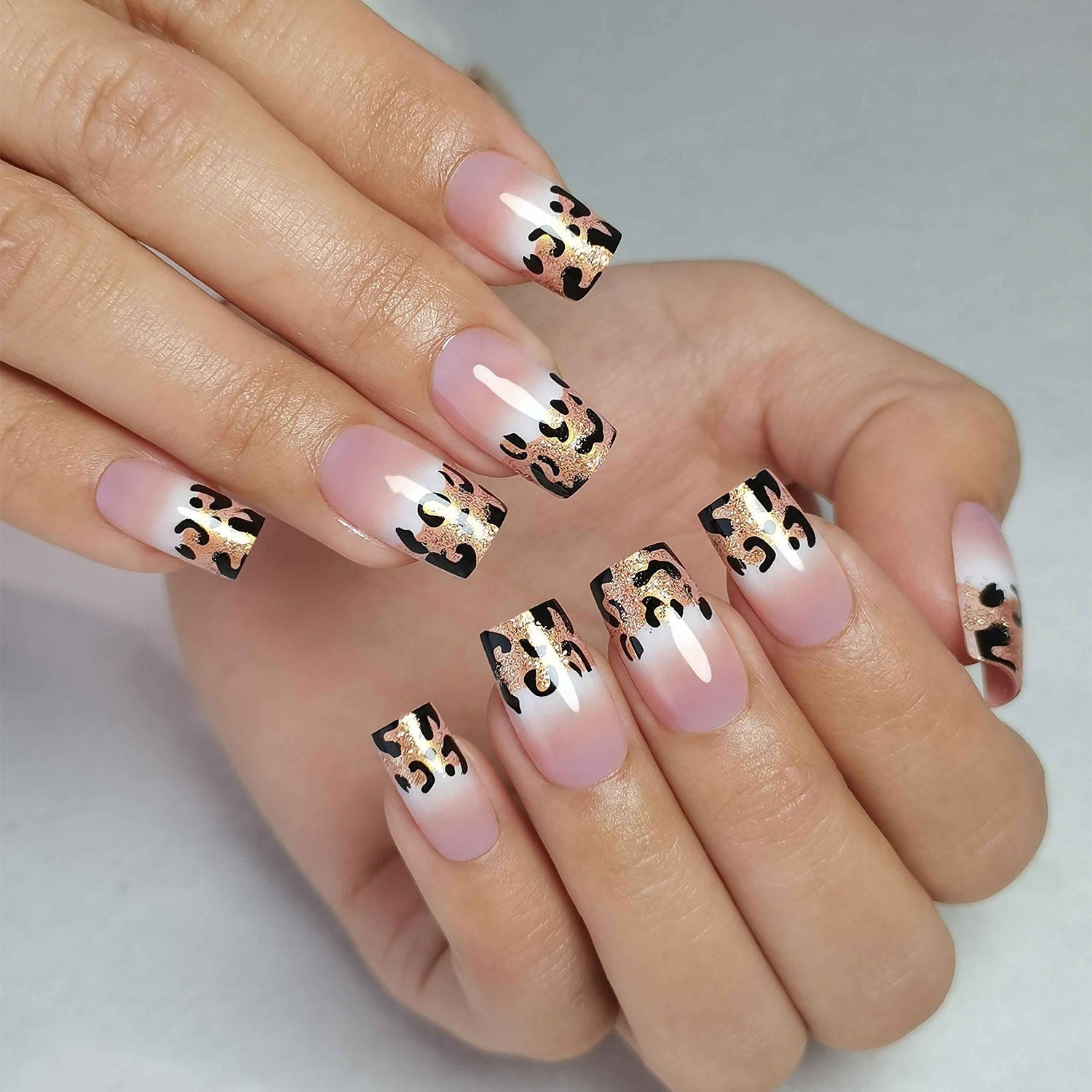 Elegant Leopard medium square press-on nails worn on a hand